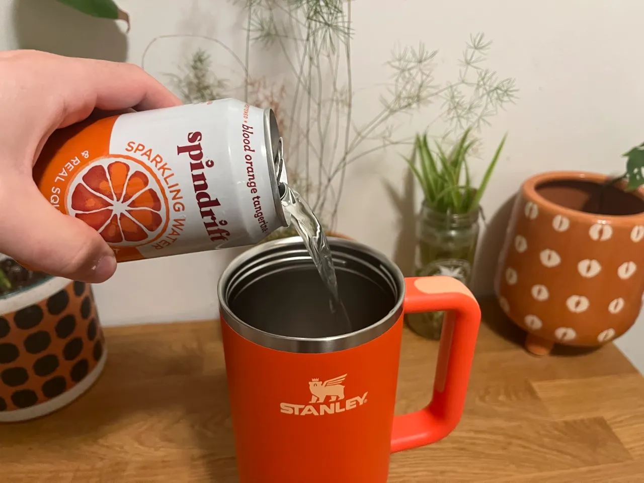 pouring-sparkling-water-soda-into-stanley-cup-tumbler-quencher pouring sparkling water soda into stanley cup tumbler quencher